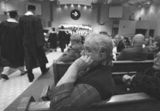 Ginger Hart appears emotional as she waits for her grandson Raymond Zoellick to walk through the isle at the Cedar Park Christian School graduation ceremoney.