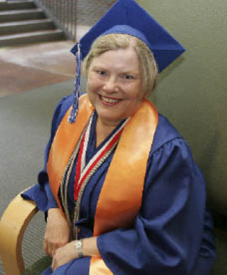 Loraine Spargo poses in her cap and gown in the Cascadia Community College Library June 26.