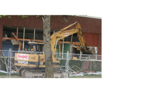 A construction crew set up shop at the old Anderson School building last week and began breaking down the brick facade to set the stage for Bothell’s downtown revitalization project.