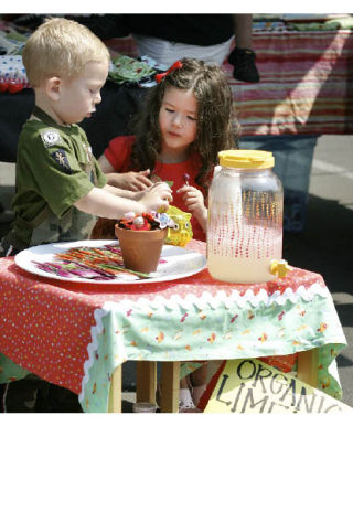 Hunter Williams and Erin Merritt sell organic limeade for 50 cents a glass in front of Hunter’s mother’s booth Aug. 8 at the Bothell Farmers Market at Country Village. More photos on page 17.