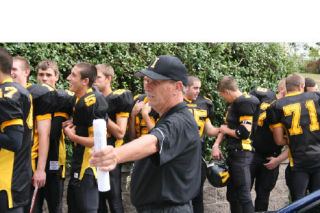 Coach Frank Naish keeps his Inglemoor players in line on the field and during team pictures Aug. 29.