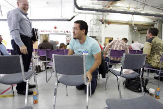 Matthew Palmer gets up after crawling under a chair during the Partners in Response meeting at the Bothell Firehouse Sept. 11.  Local faith groups met with the city’s Emergency Preparedness Team.