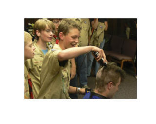 Troop 627 senior patrol leader Jordan Howlett shaves scoutmaster Sterling Crockett’s head during a Sept. 23 gathering.