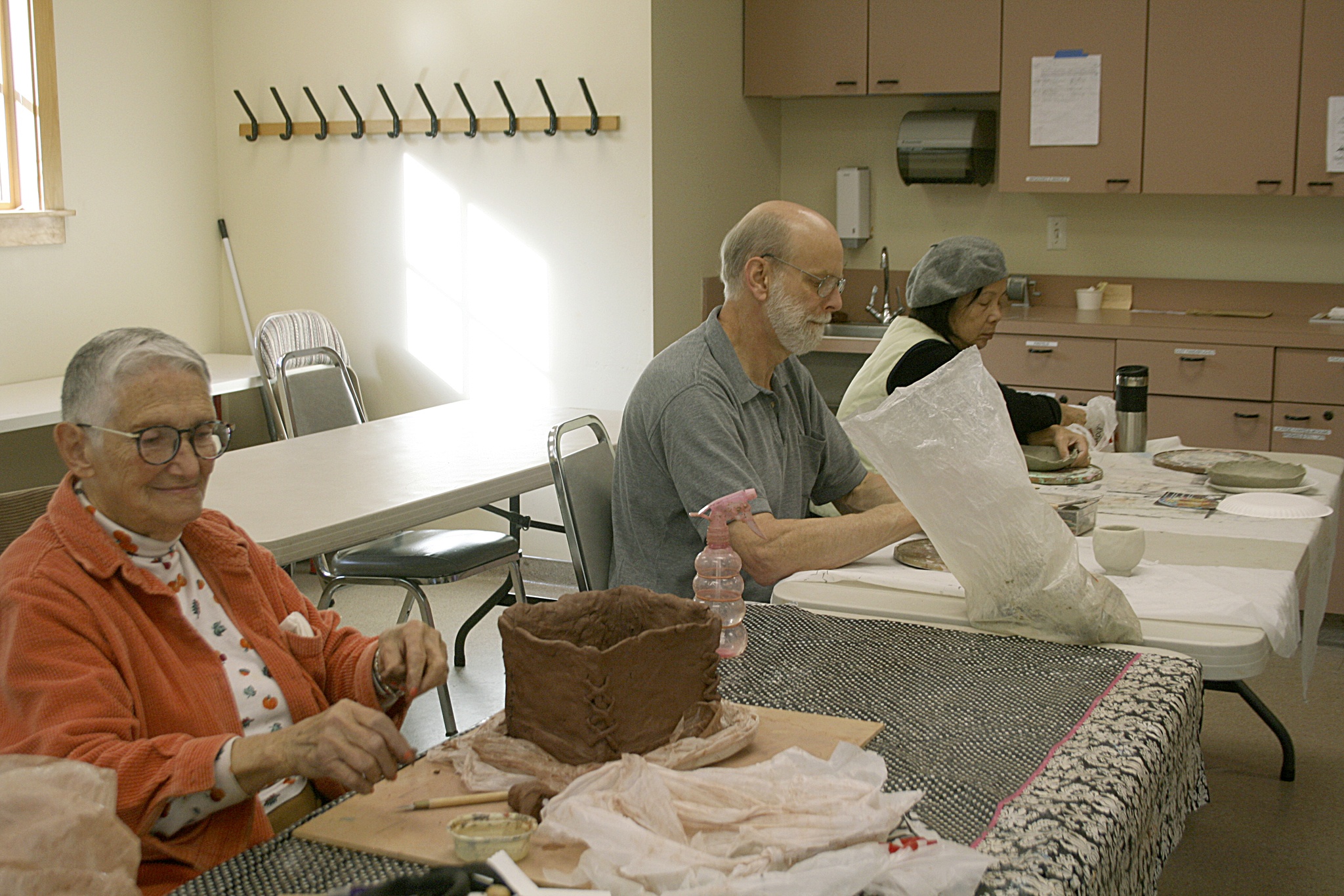 Delores Jones, John Buckingham and Annie Nininger participate in a ceramics class at the Northshore Senior Center in Bothell. CATHERINE KRUMMEY/Bothell Reporter