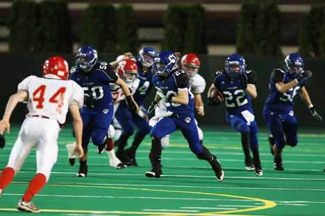 Bothell High’s Chase Golka (No. 50) and Bobby Gagnon (No. 23) lead the way for Luke Proulx (No. 22) during last Friday’s 61-0 victory over Stanwood High at Pop Keeney Field. The No. 1 Cougars will take on Rogers in the state playoffs at 7:30 p.m. this Friday at Pop Keeney.