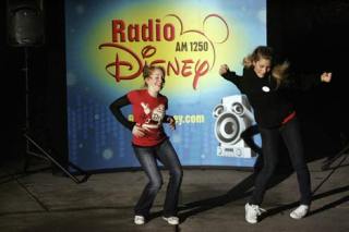 Radio Disney’s Hannah Tripp and Jordynn Otto dance to the beat of “Fuego” at Bothell’s annual Winterfest last Friday night.