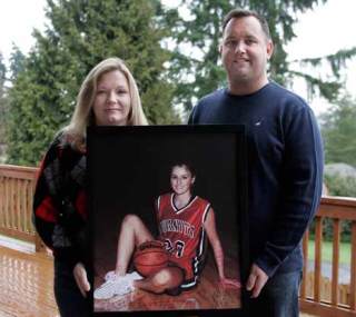Vanessa White and husband Jeff display a photo of Chantel Still