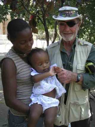 Claude Gagnon visits with Haitian residents during one of his volunteer trips.