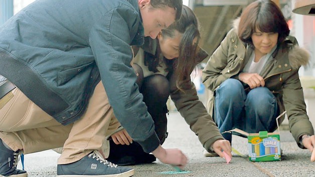 Cascadia College students decorate Bothell's Main Street with chalk drawings and slogans.