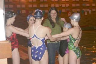 Coach Joy Bloser shares a laugh with her age 12-15 Seattle Synchro members