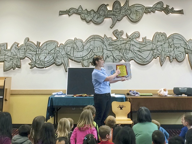 E-911 program manager III Kayreen Lum reads from Emery and the Ice Carnival to teach the kids about how and when to call 911 at the Bothell Library. Bothell was the first stop on the tour of 13 local libraries. Contributed photo