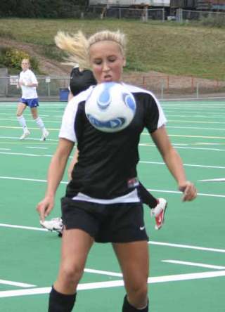 Inglemoor High’s Lacey London controls the ball near the sideline during first-half action.