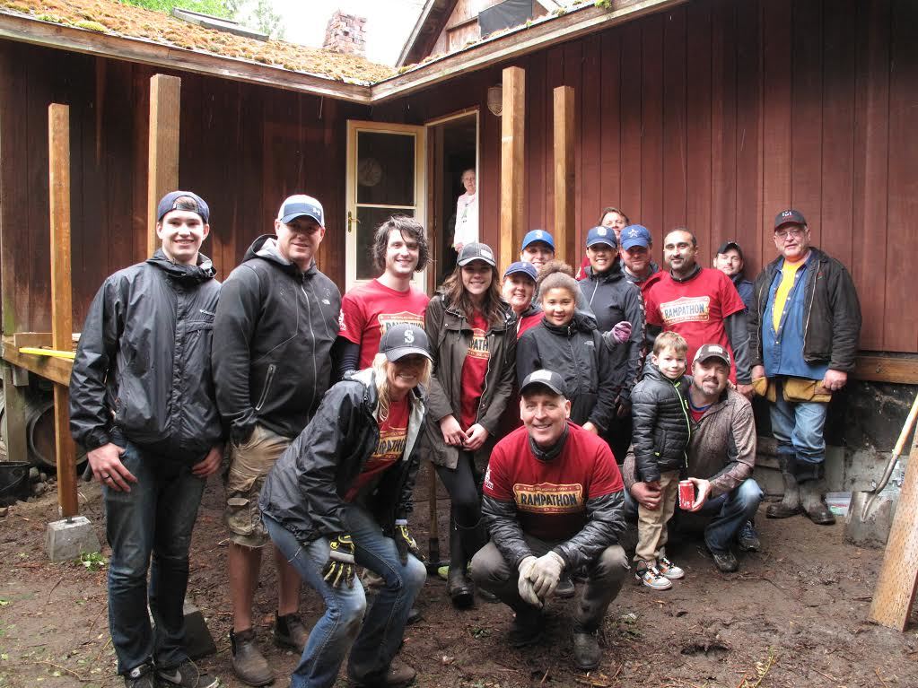 Volunteers from the Builders Capital team pose in front of the deck they were constructing for Robert and Patricia Leas in Kenmore. Contributed/Ellen Aebischer