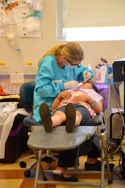 A child receives free dental care during a past Care Day. Contributed photo
