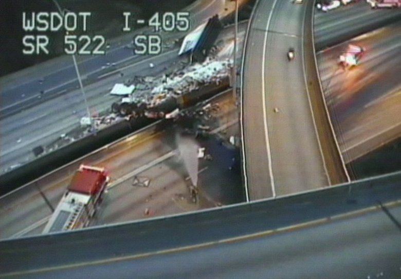 A semi-truck lies smashed between the north and southbound lanes of I-405 in Bothell. Photo courtesy of WSDOT.
