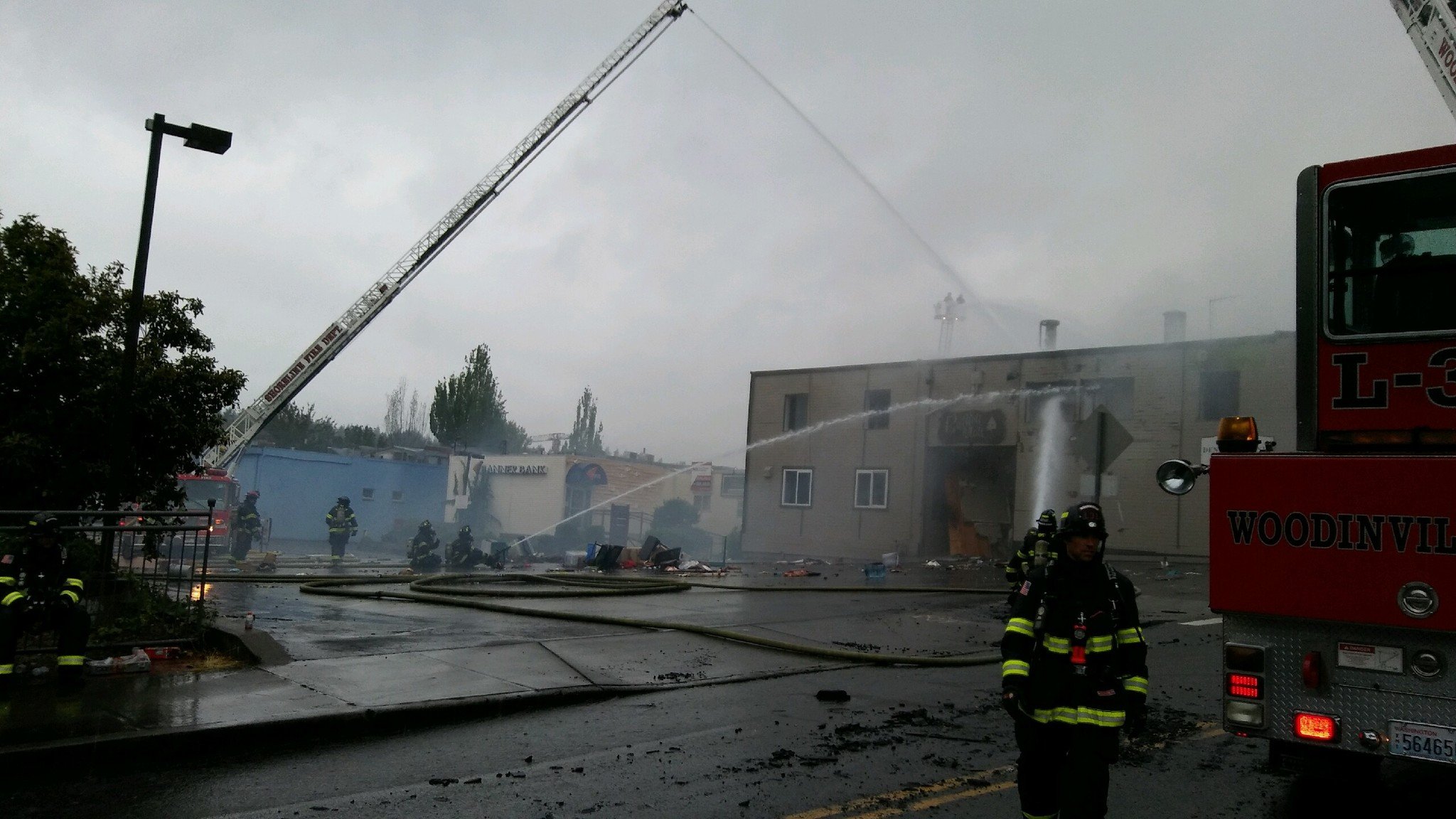 Firefighters douse a massive fire in downtown Bothell this morning. Aaron Kunkler
