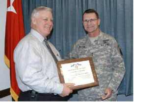 Bothell resident Bob Fowler (left) accepts a plaque with a certificate of appreciation as head of the team winning the U.S. Army Reserve Command’s 2008 Financial Management Team Award from Maj. Gen. Chris Ingram