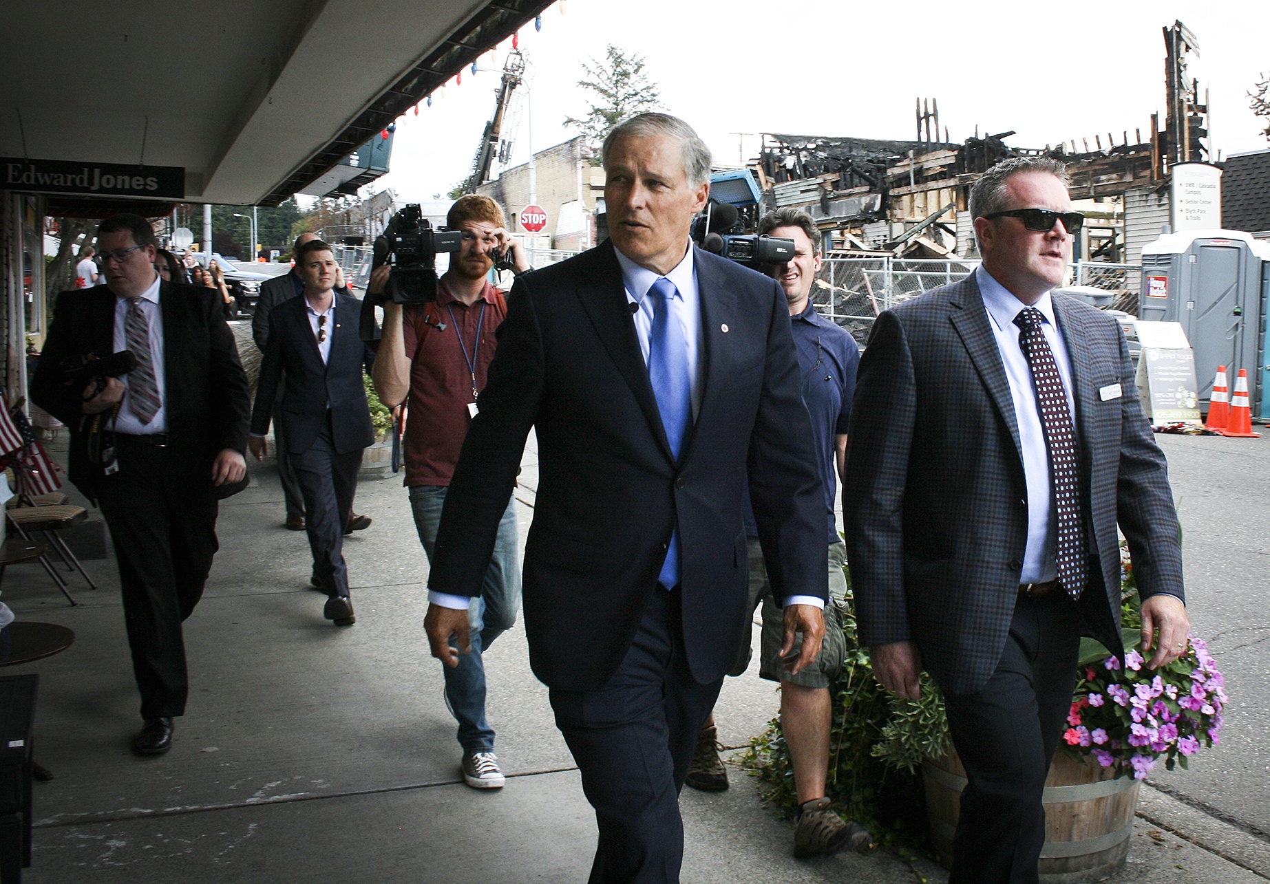 Washington State Gov. Jay Inslee (center) and Bothell Mayor Andy Rheaume (right) tour the area of downtown Bothell damaged by a July 22 fire on Aug. 10. Matt Phelps / Bothell Reporter