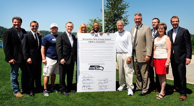 King County Council stands with representatives of the Seahawks.