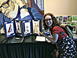 Bothell High School senior Grace While poses with her costume designs which took first place during an international competition earlier this summer. Contributed photo