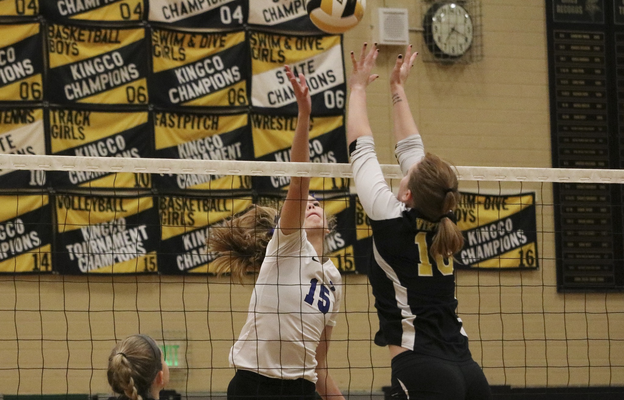 Bothell junior Maddie Butters (15) tips the ball over the outstretched hands of Inglemoor’s Kristen Compton in the second set of Bothell’s 3-0 win on Wednesday in Kenmore. JOHN WILLIAM HOWARD/Bothell-Kenmore Reporter