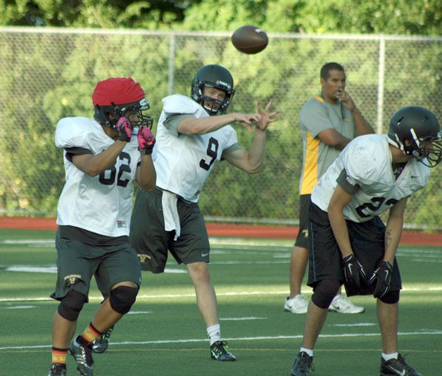 Viking coach DJ Baddeley watches on as quarterback  Bryce Larson leads the offense during a preseason practice.
