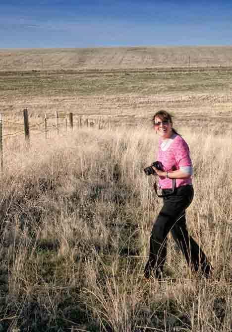 Artist and photographer Charlene Collins Freeman roams a field on a photo shoot.