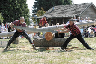 Wood chips fly as a pair of lumberjacks saw away during last year’s Evergreen State Fair. This year’s fair runs Aug. 21 through Sept. 1 at the fairgrounds