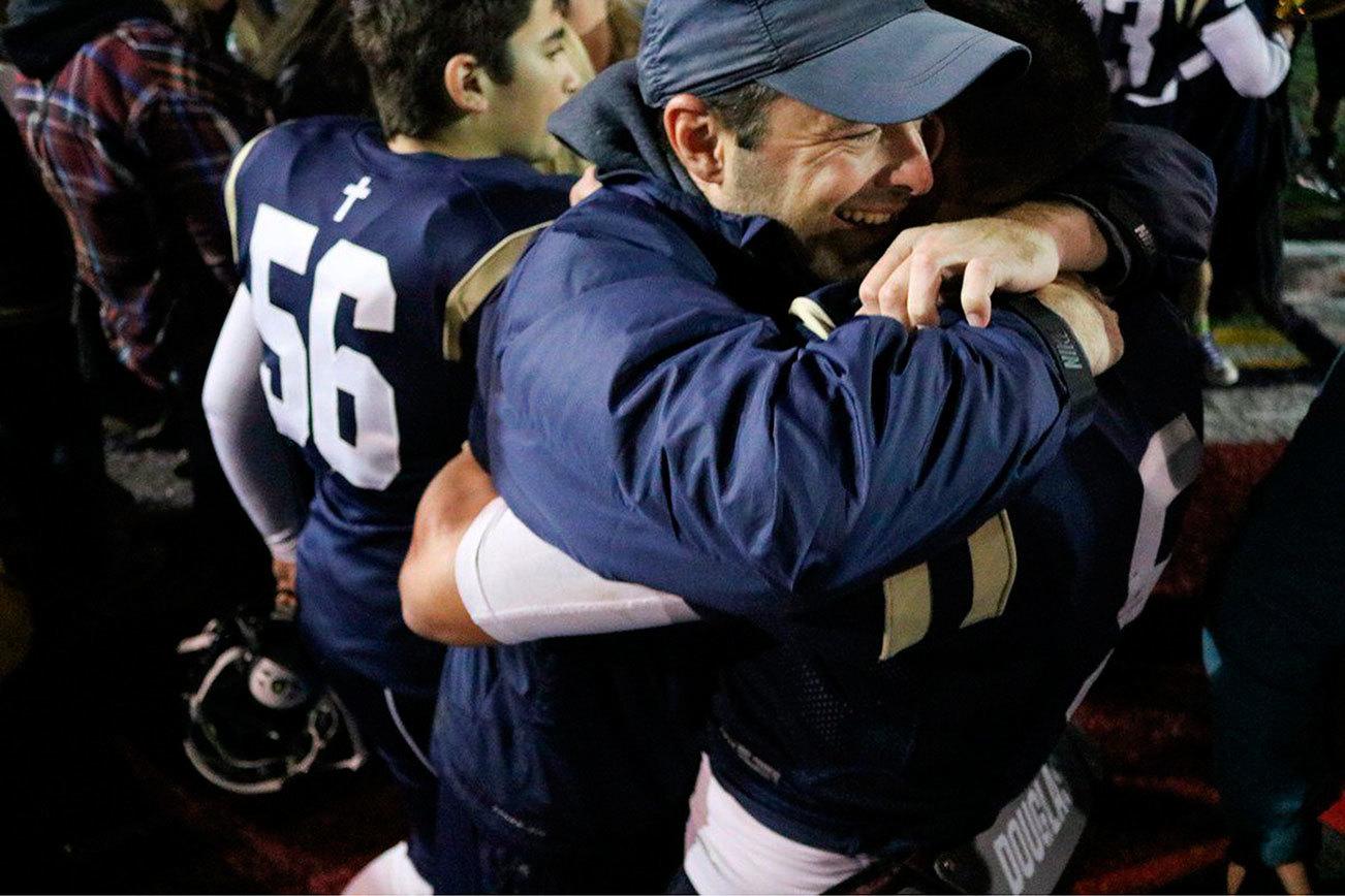 Cedar Park Christian football coach Bill Marsh hugs senior Josiah Sergeant following the Eagles’ 28-25 victory over Cedarcrest on Oct. 21 at Juanita High School. JOHN WILLIAM HOWARD/Bothell-Kenmore Reporter