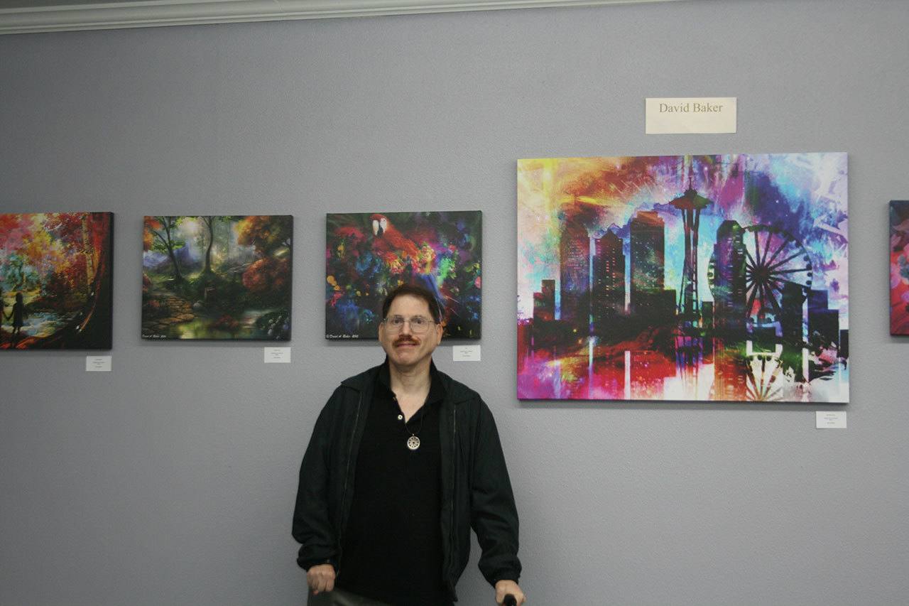 Artist David Baker poses with some of his pieces on display in the Museum of Special Art’s “Colors of My World” exhibit. CATHERINE KRUMMEY/Bothell Reporter