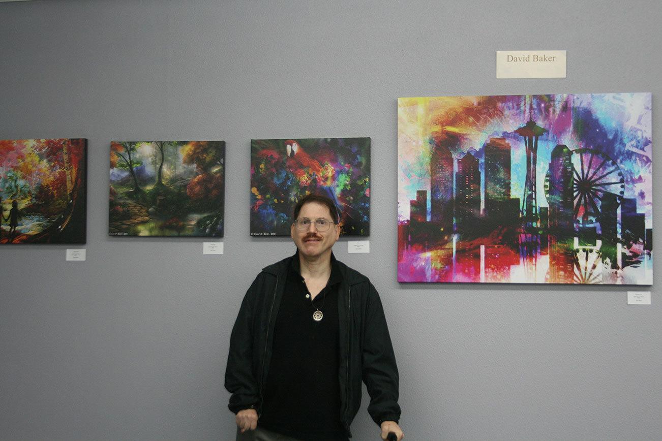 Artist David Baker poses with some of his pieces on display in the Museum of Special Art’s “Colors of My World” exhibit. CATHERINE KRUMMEY/Bothell Reporter