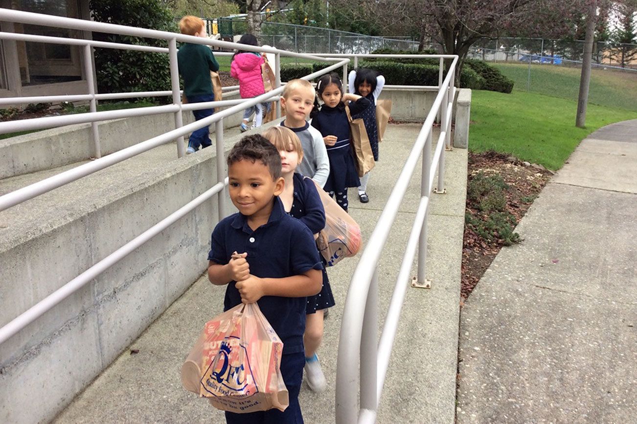Students at Evergreen Academy Preschool in Bothell collected 542 pounds of non-perishable food items to benefit nonprofit organization, Hopelink. Following the drive, students helped fill the Hopelink van with donations. Contributed photo