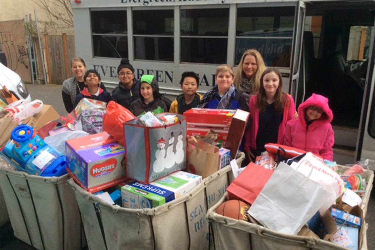 Evergreen Academy students pose with some of the items donated to Childhaven. Contributed photo