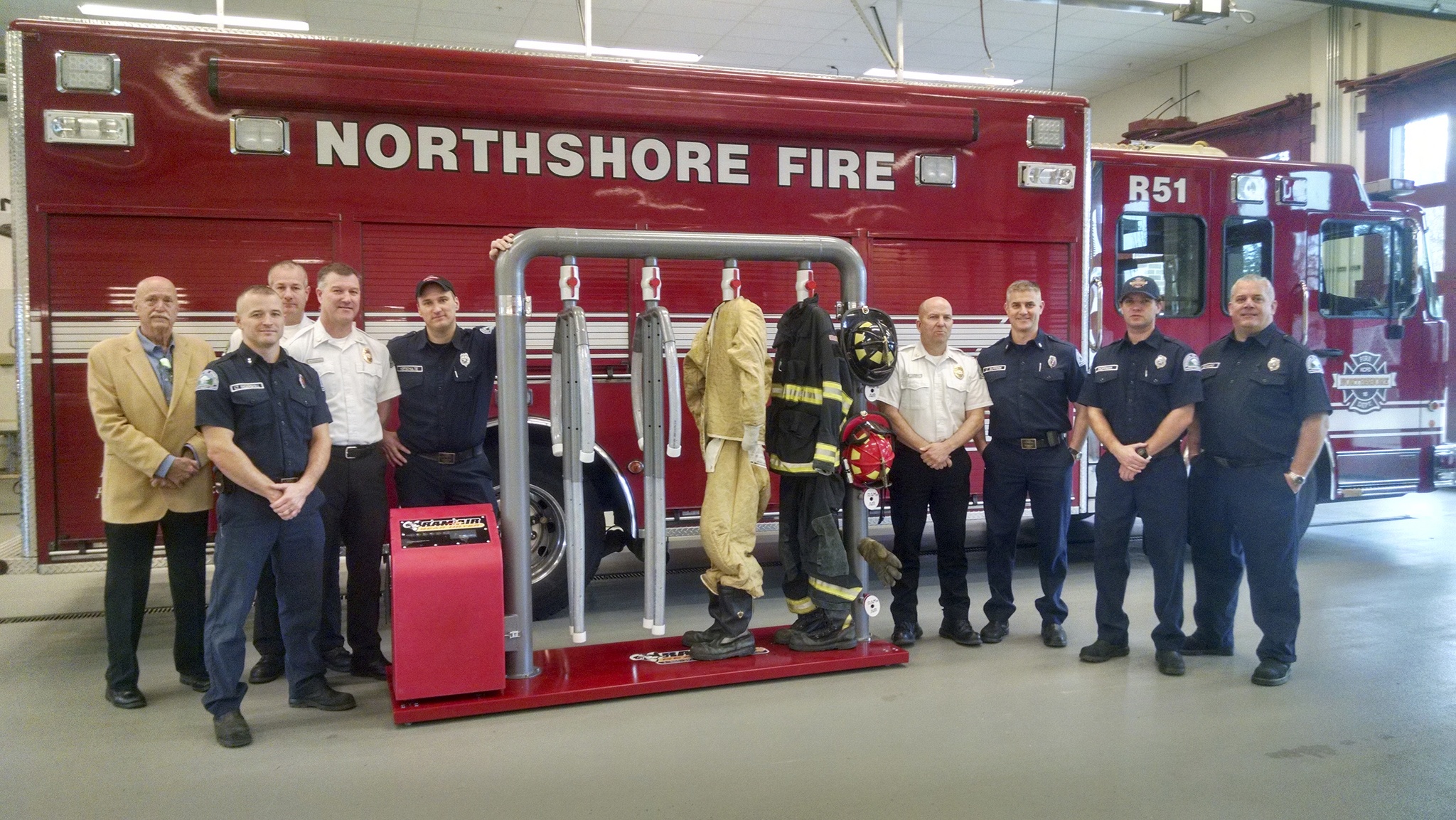 Ram Air Gear Dryer Director of Sales David Adams (left) presents a dryer, won in his company’s Hometown Heroes contest, to Northshore Fire Department staff in Kenmore. CATHERINE KRUMMEY/Kenmore Reporter