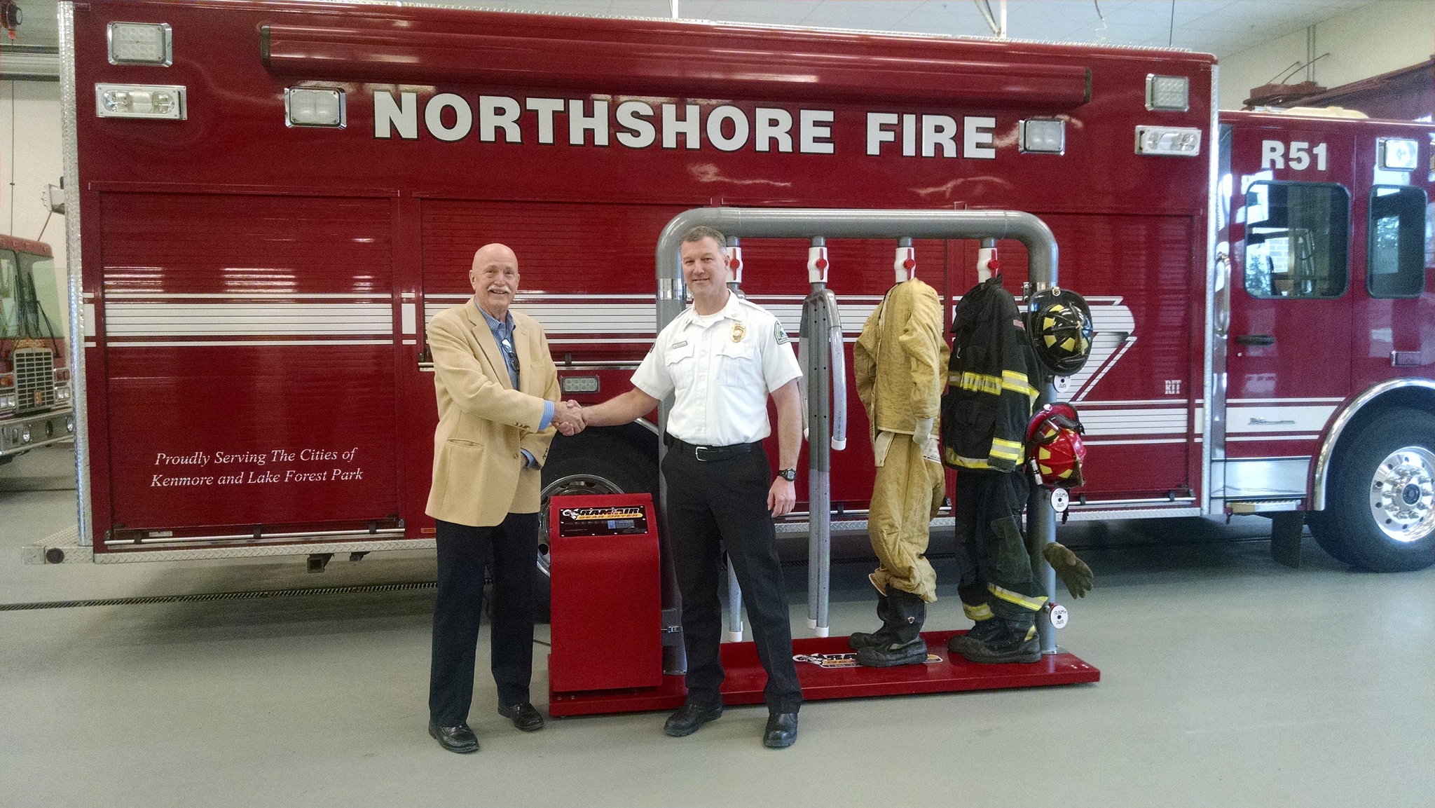 Ram Air Gear Dryer Director of Sales David Adams (left) presents a dryer, won in his company’s Hometown Heroes contest, to Northshore Fire Department Deputy Chief Eric Magnuson, who entered the contest on the department’s behalf. CATHERINE KRUMMEY / Kenmore Reporter