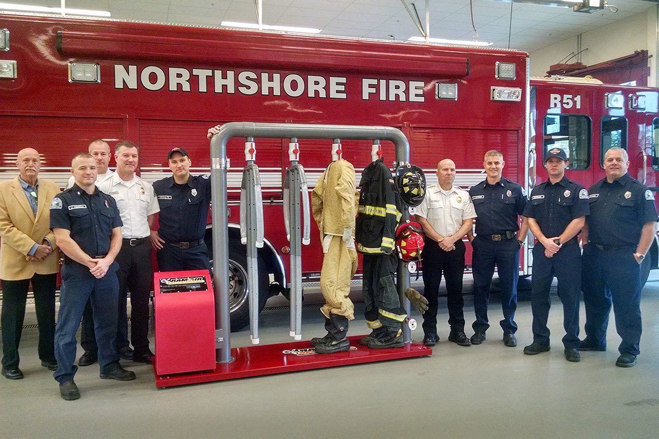 Ram Air Gear Dryer Director of Sales David Adams (left) presents a dryer, won in his company’s Hometown Heroes contest, to Northshore Fire Department staff in Kenmore. CATHERINE KRUMMEY/Kenmore Reporter