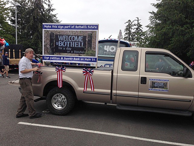 Richard Olson works on a parade float to promote his effort to bring back the “Welcome to Bothell for a day or a lifetime” sign. Contributed photo