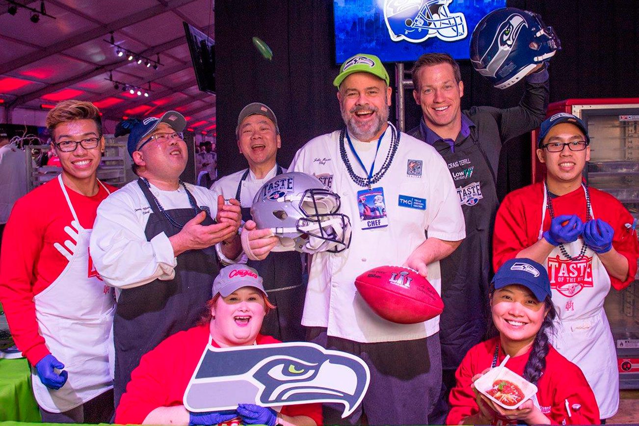 Chef John Howie (center) and former Seattle Seahawk Craig Terrill are joined by John Howie Restaurants employees to raise money for Food Lifeline as part of the NFL’s Kick Hunger Challenge. Contributed photo