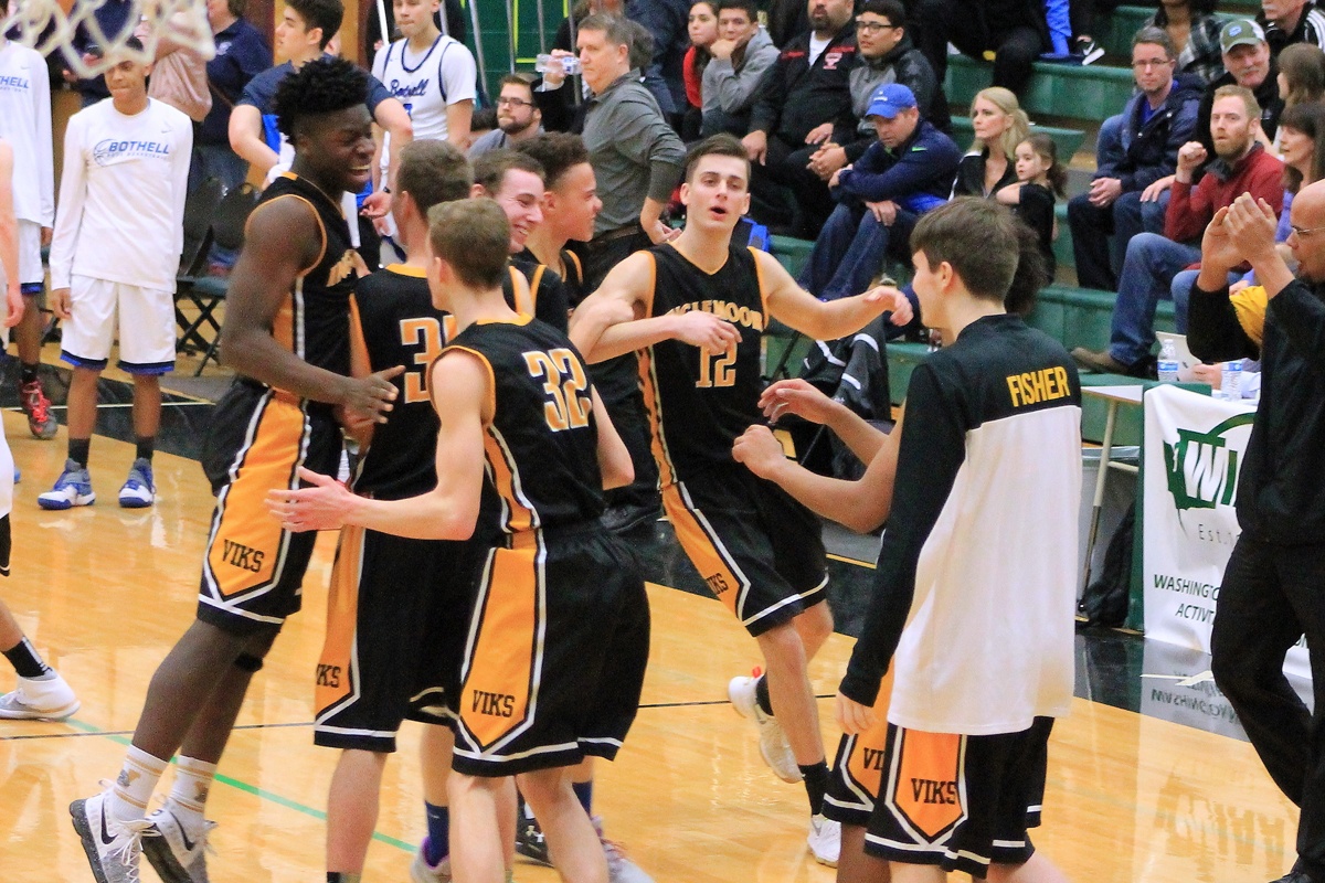 The Inglemoor High boys basketball team celebrates after beating Bothell, 49-47, on Saturday in Mill Creek, qualifying for the state tournament. SEAN VALLEY/Courtesy photo