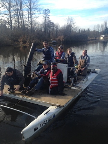 Volunteers move across Swamp Creek in a Hobie Cat with supplies during a previous replanting event. Contributed photo