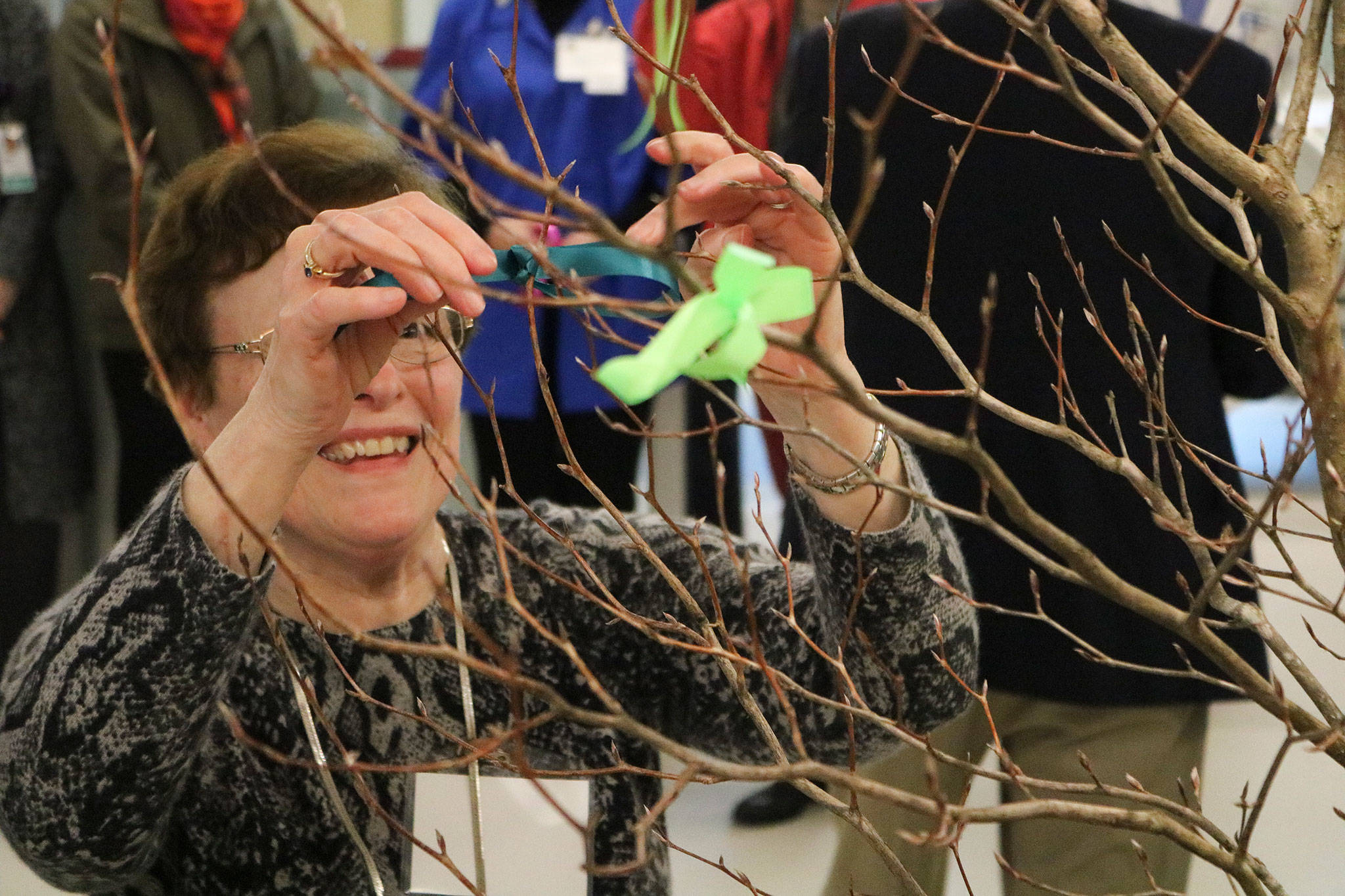 Longtime Kirkland resident and EvergreenHealth Comissioner Rebecca Hirt was one of several to tie a ribbon to a tree as part of a dedication ceremony on March 3 at EvergreenHealth in Kirkland. The new progressive care unit began taking patients on March 6. JOHN WILLIAM HOWARD/Kirkland Reporter