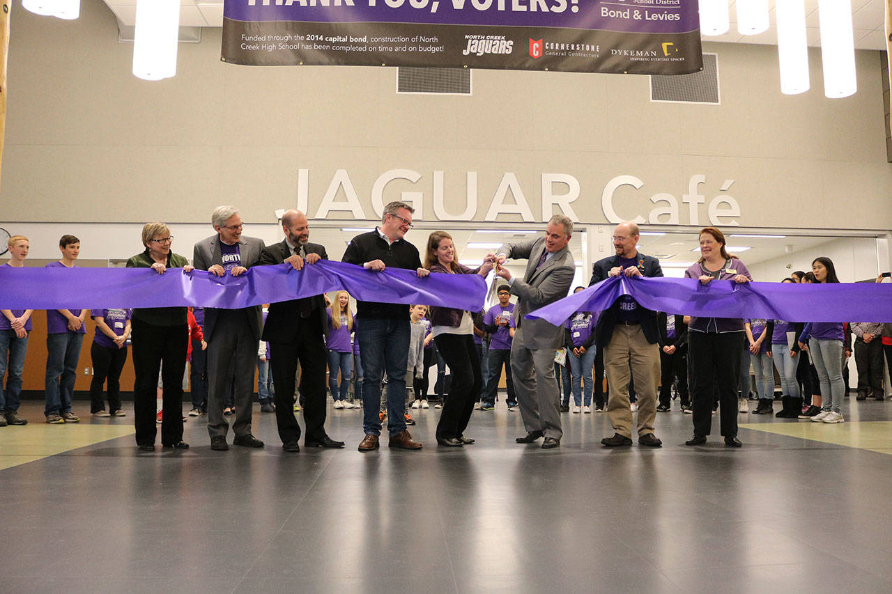 North Creek High School principal Eric McDowell, center, cuts the ribbon to signal the official opening of NCHS in November 2016. The school will host an education funding forum on March 11. Reporter file photo