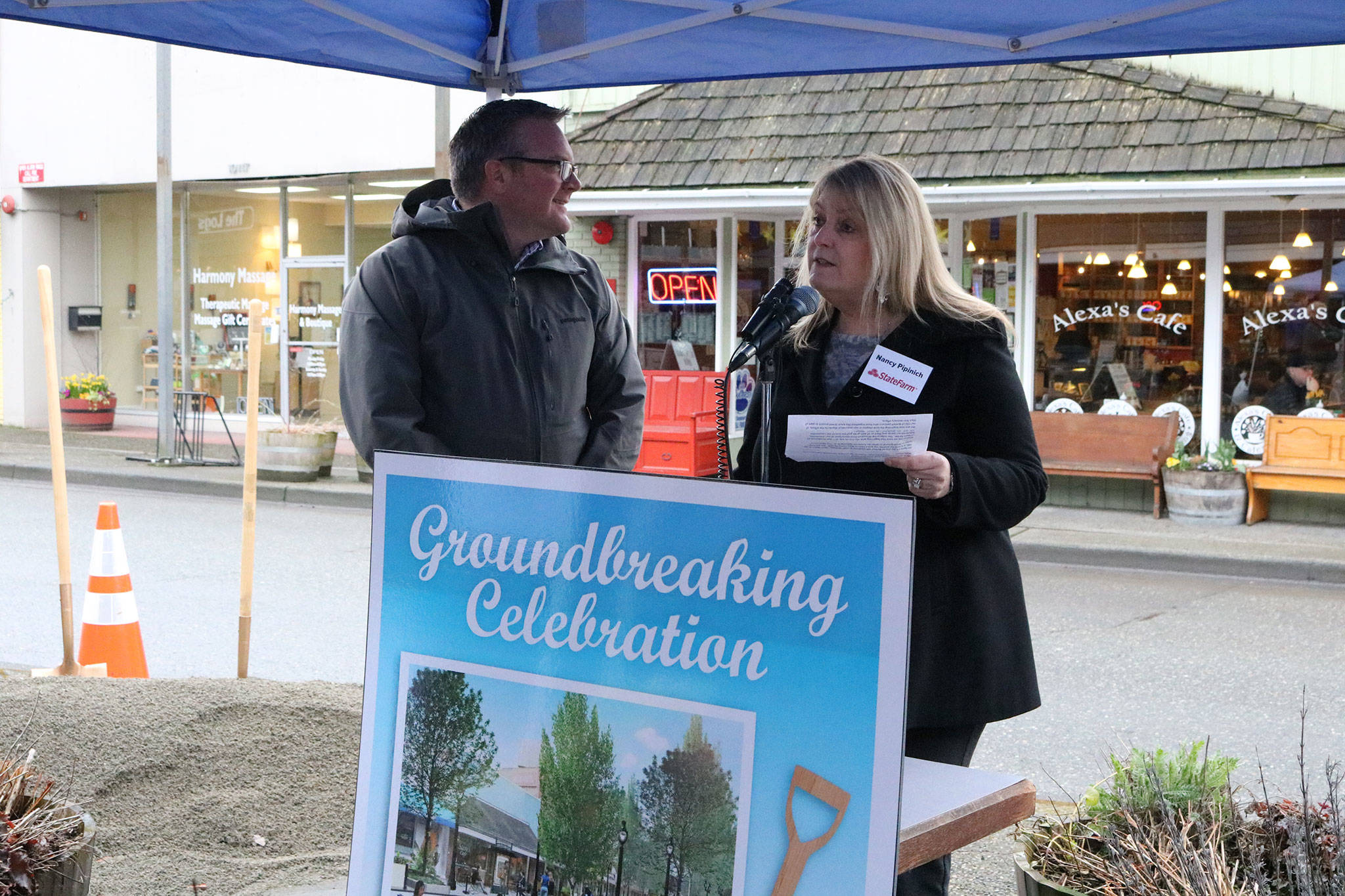 Bothell Mayor Andy Rheaume looks on as State Farm owner Nancy Pipinich speaks during the groundbreaking ceremony for the Main Street Enhancement Project on March 28. CATHERINE KRUMMEY / Bothell Reporter