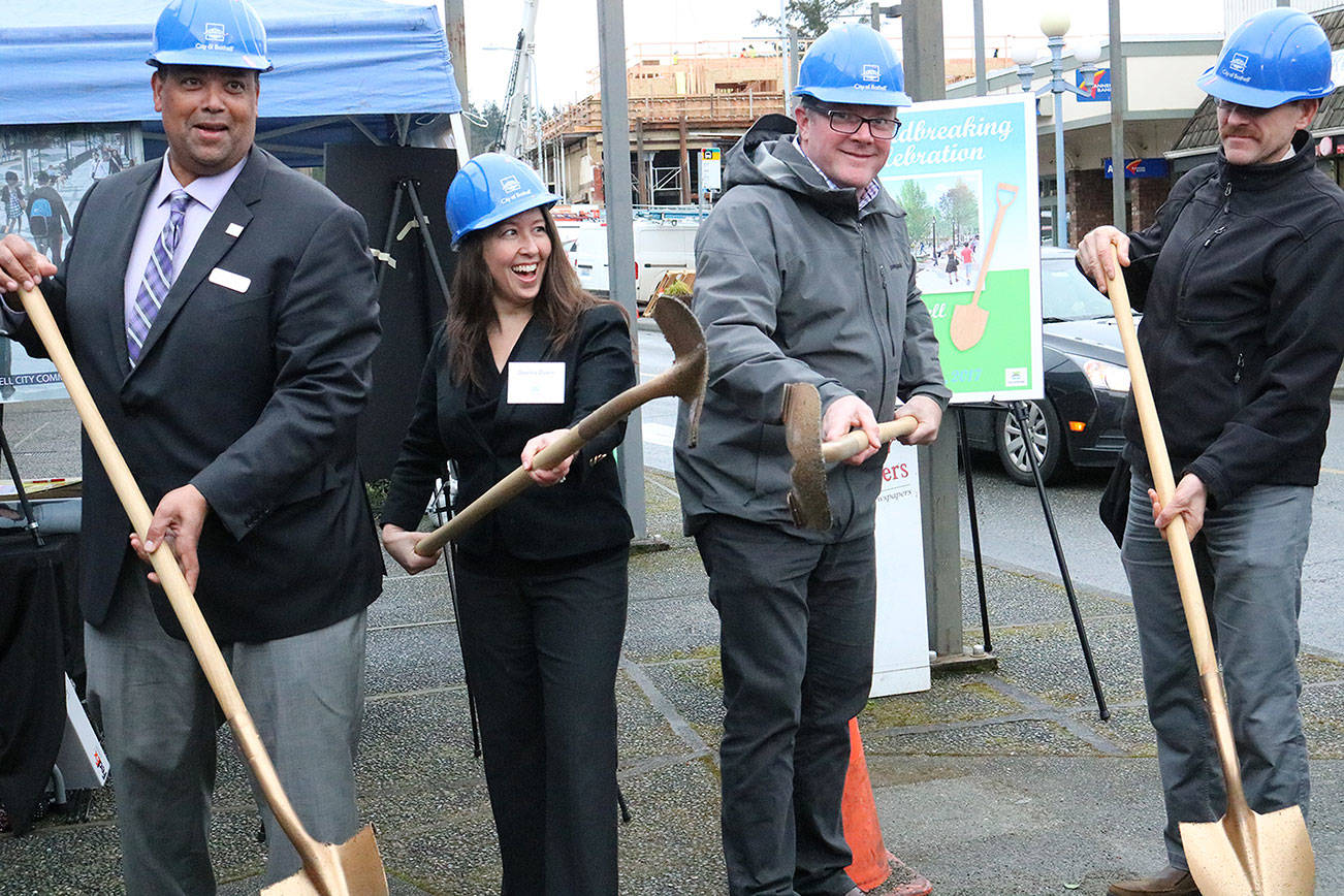 Bothell City Councilmember James McNeal, Deputy Mayor Davina Duerr, Mayor Andy Rheaume and Transportation Improvement Board Engineer Greg Armstrong participate in the groundbreaking ceremony for the Main Street Enhancement Project on March 28. CATHERINE KRUMMEY / Bothell Reporter