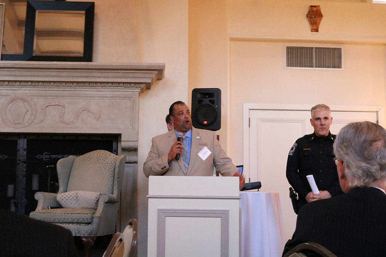 Bothell City Councilmember James McNeal and Bothell Police Captain Mike Johnson give a presentation on the “Cops and Cards” program at a Sound Cities Association dinner in Kenmore. CATHERINE KRUMMEY / Kenmore Reporter