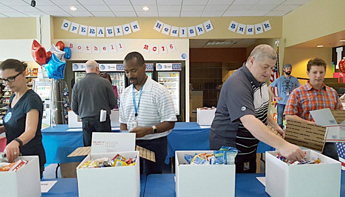 AT&T employee volunteers in Bothell box 300 care packages that were delivered to military personnel all around the world last June. Reporter file photo