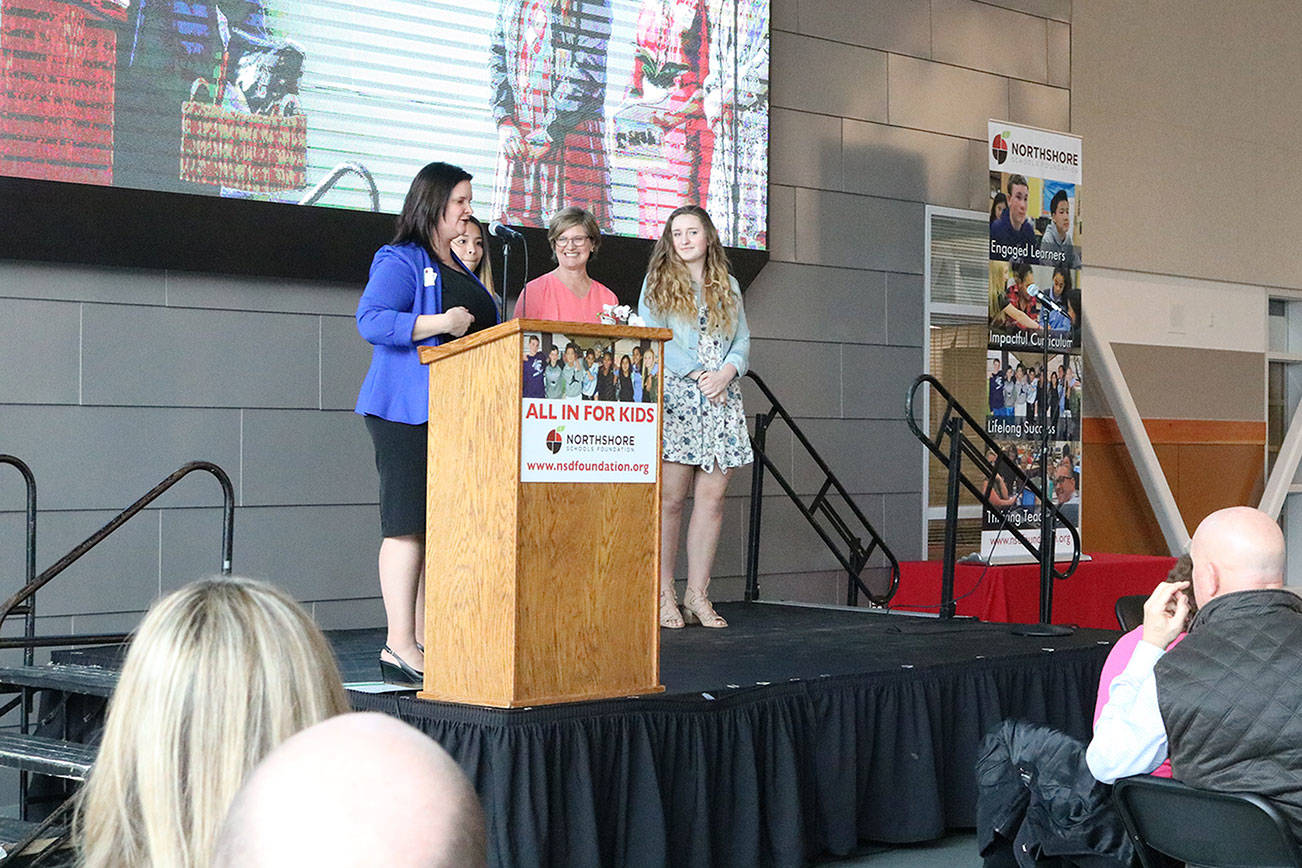 Northshore Schools Foundation Executive Director Carmin Dalziel presents Northshore Junior High School teacher Trudy Swain with the Innovative Educator Award. They are joined on stage by two of Swain’s students, Jazmin Valdez and Julia Zahn. CATHERINE KRUMMEY / Bothell Reporter