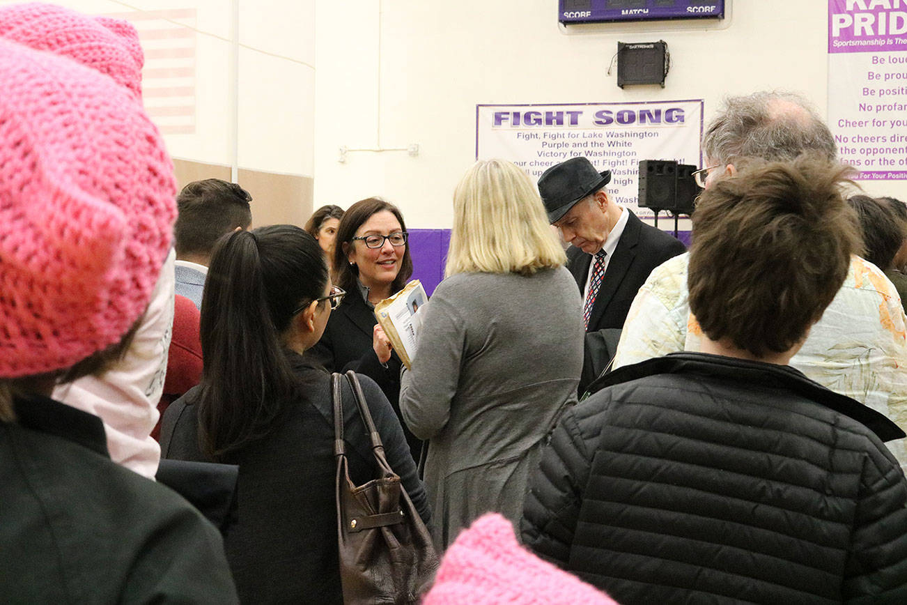 Congresswoman Suzan DelBene (center) speaks with constituents following a town hall event at Lake Washington High School in Kirkland. CATHERINE KRUMMEY/Kirkland Reporter