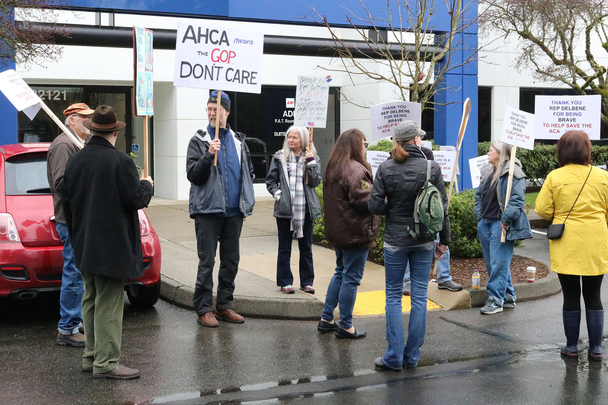 Locals participate in a Indivisible North Seattle-organized rally outside of 1st Congressional District Rep. Suzan DelBene’s Bothell office. They wanted to show support for DelBene in her opposition to the Republican-proposed health care reforms in the U.S. House of Representatives. CATHERINE KRUMMEY / Bothell Reporter