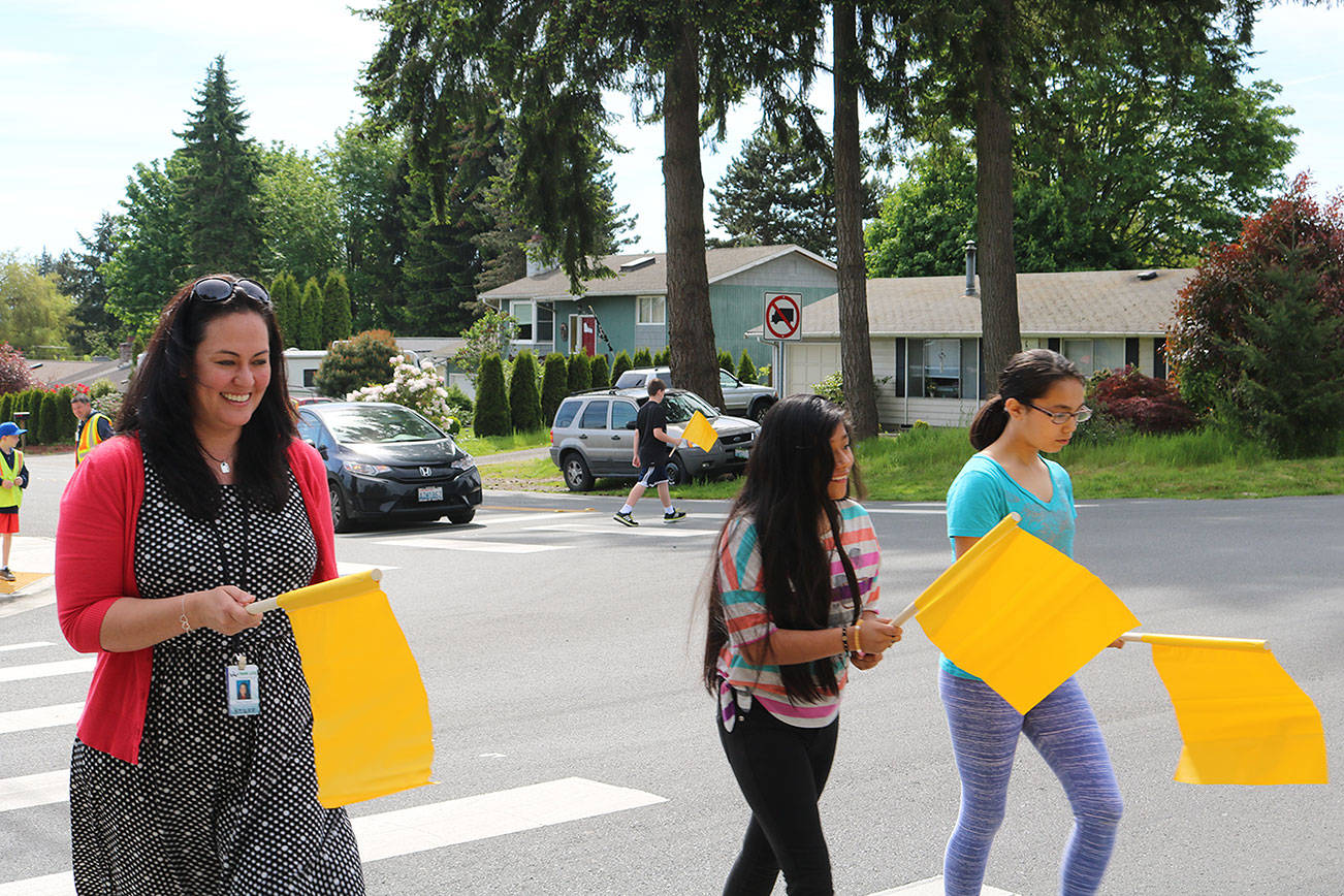 Frank Love Elementary School staff and students use the new pedestrian flags at the intersection of Fourth Avenue West and 224th Street Southwest. CATHERINE KRUMMEY, Bothell/Kenmore Reporter